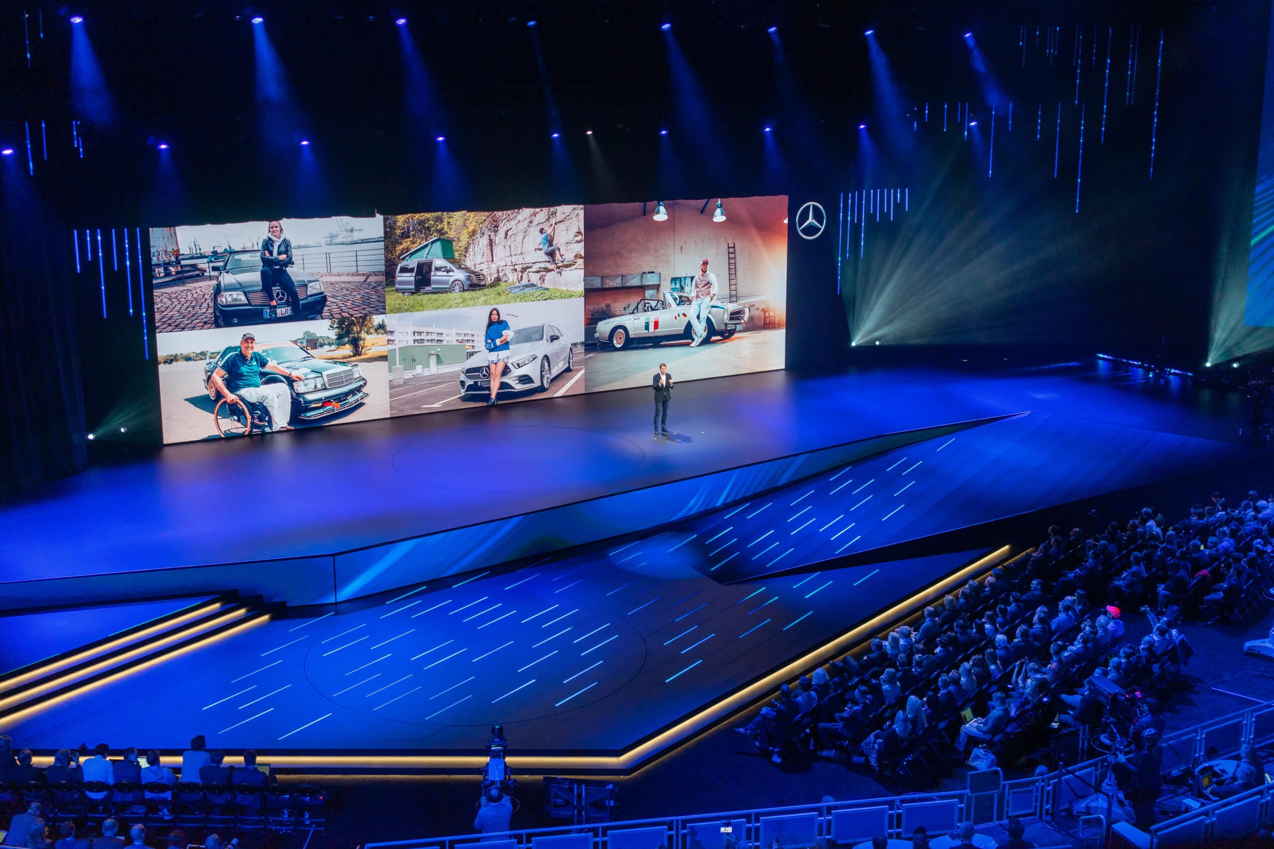 Shot of the full stage and screen with man presenting at CES