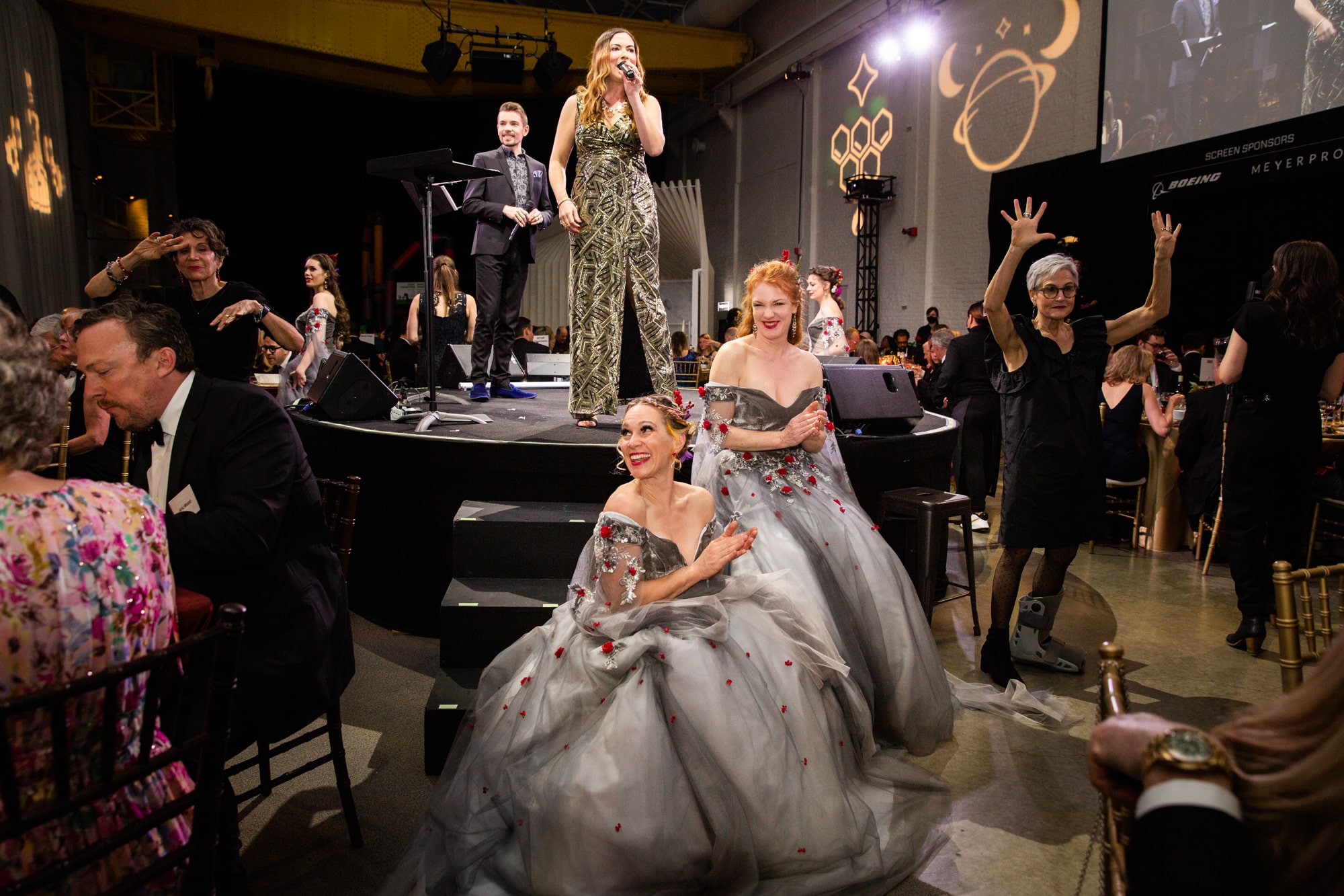 Image of women in fancy ballgowns as part of the theme for the 2022 OMSI gala