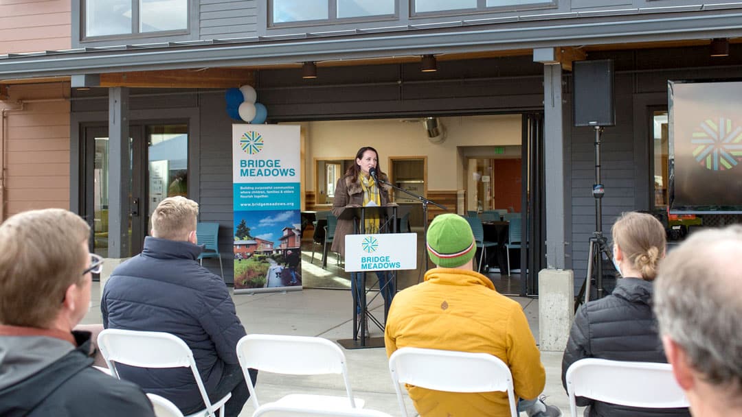 Image of person speaking at the Bridge Meadow's Redmond Grand Opening
