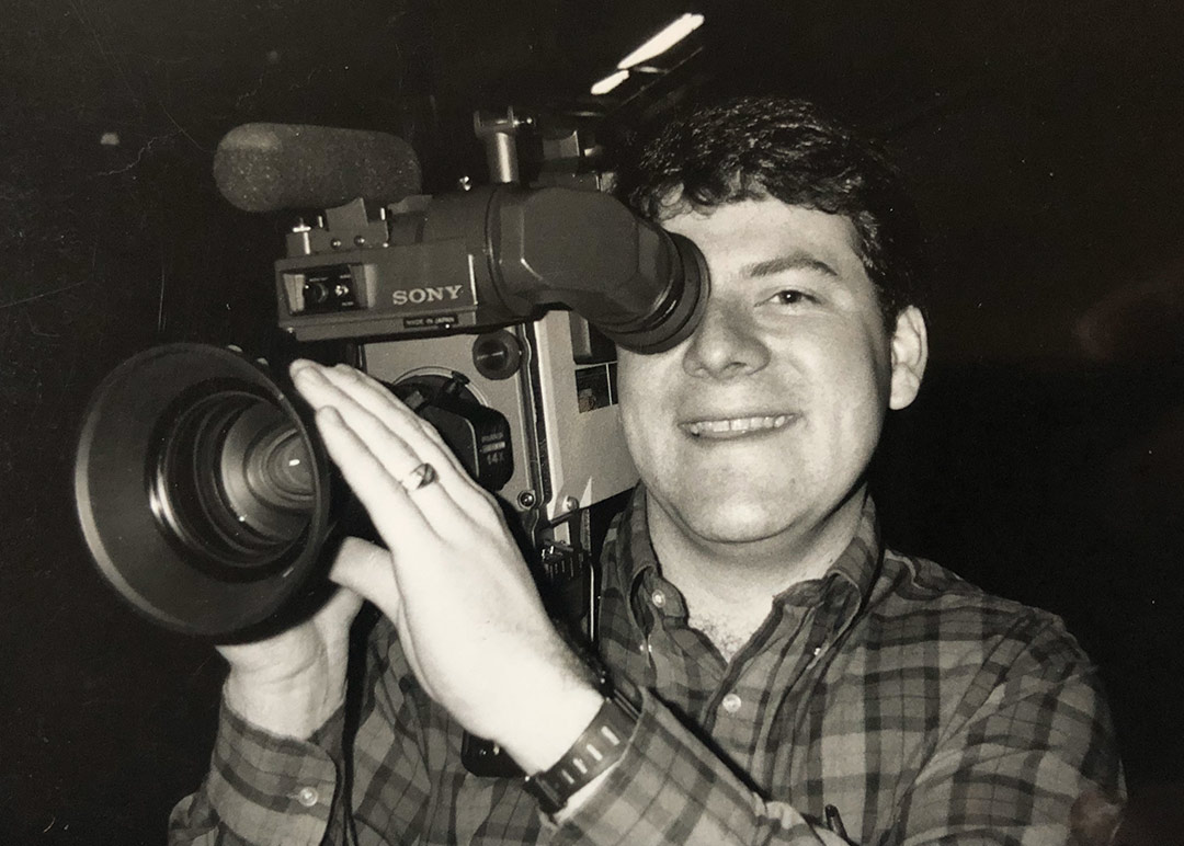 Image of Steve when he was younger holding a camera