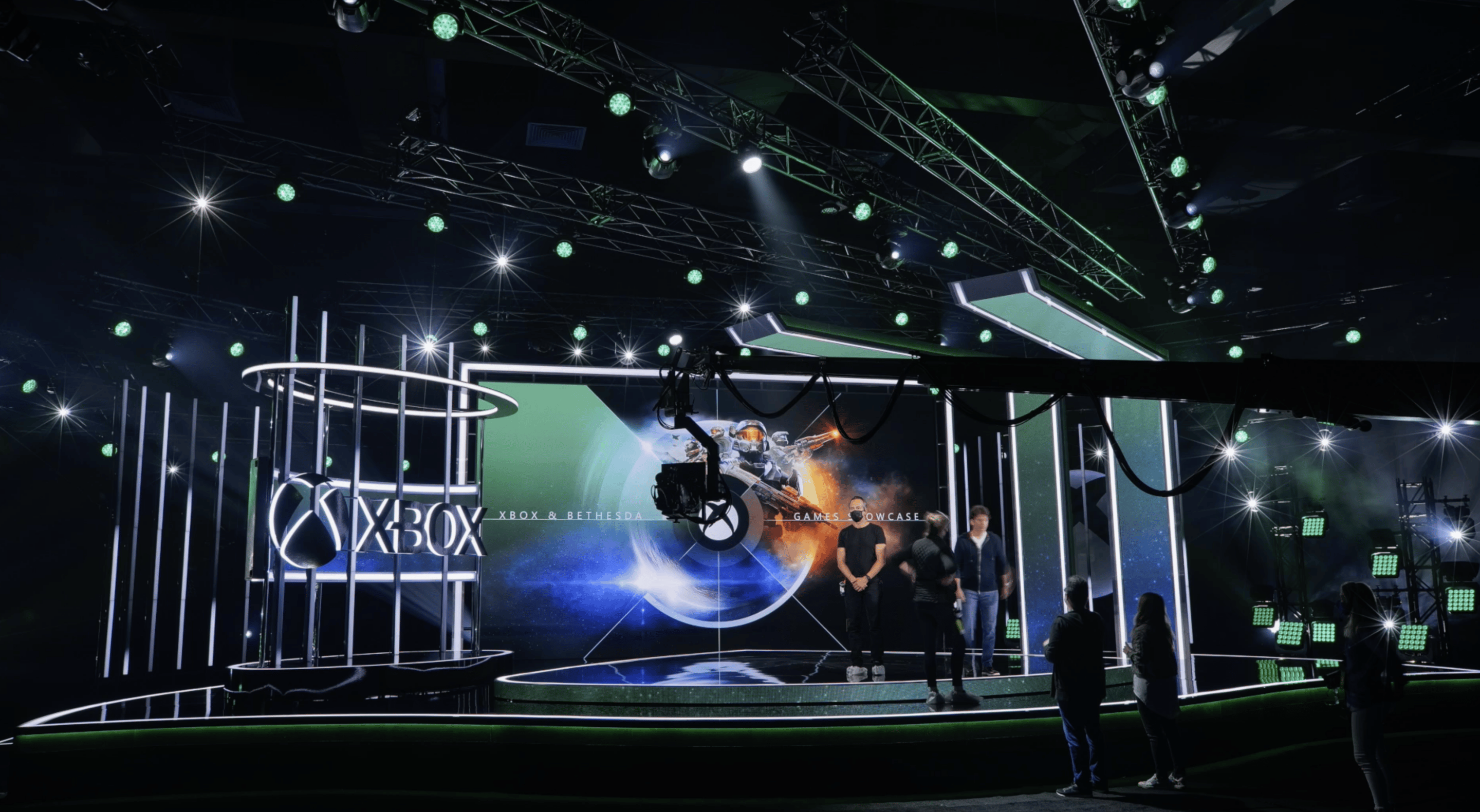 People standing on stage in front of the Xbox Showcase screen 