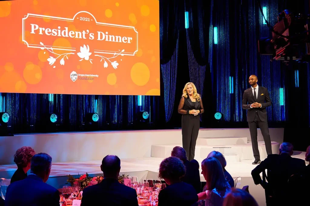 Presenters speaking to an audience during a corporate event with live audio production