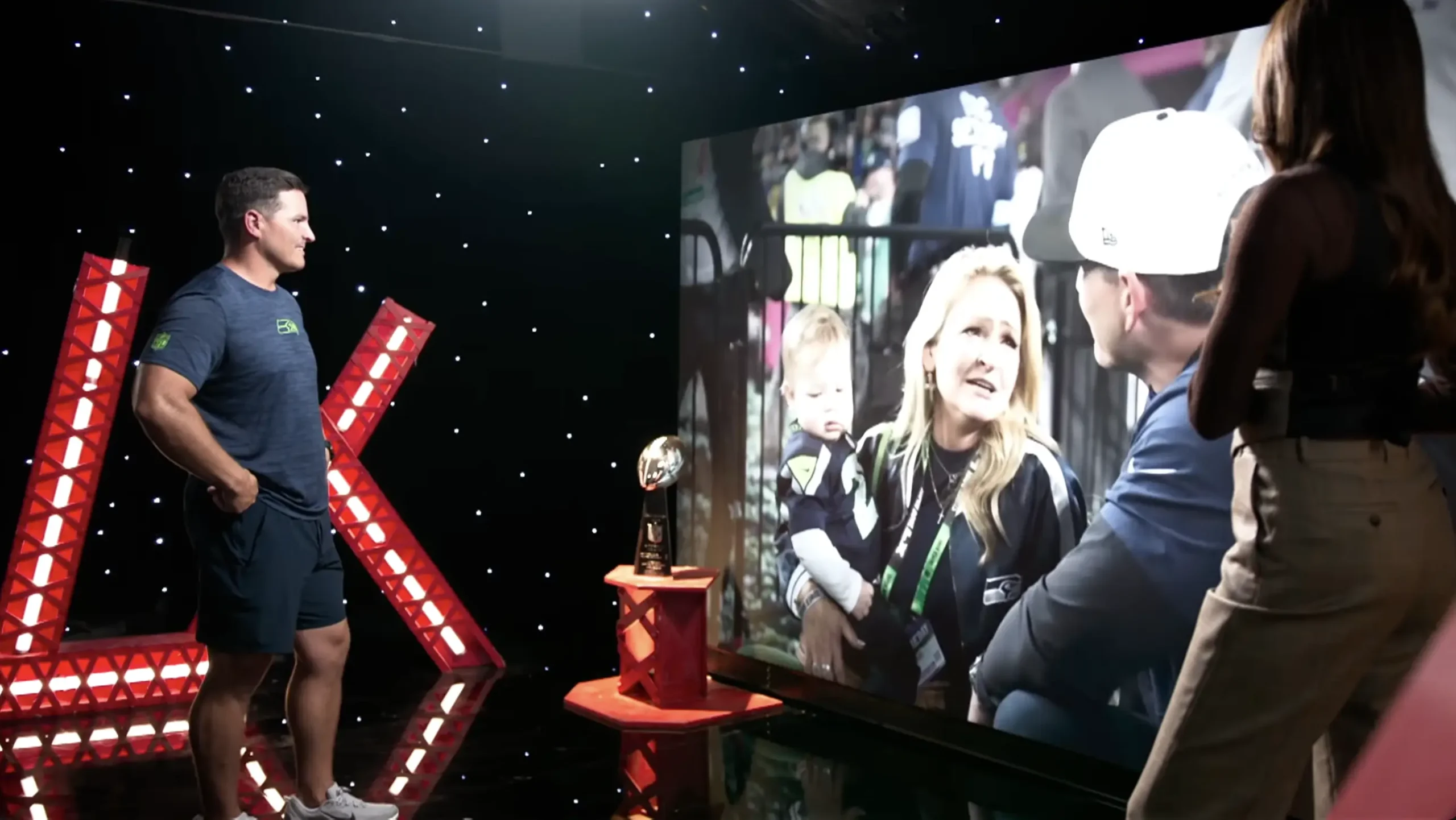 Seattle Seahawks broadcast set with on-camera talent in front of an AOTO LED wall and star drop drape for NBC Universal.